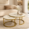 Aurelia 2-piece marble-top nesting coffee table set with gold chrome legs in a modern living room