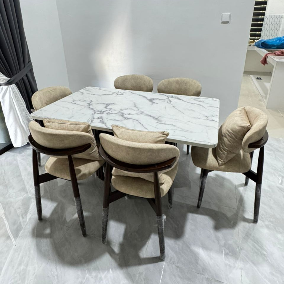 A modern 5-piece dining set featuring a rectangular white marble-patterned table and five upholstered chairs with dark wood frames, shown in a home interior setting.