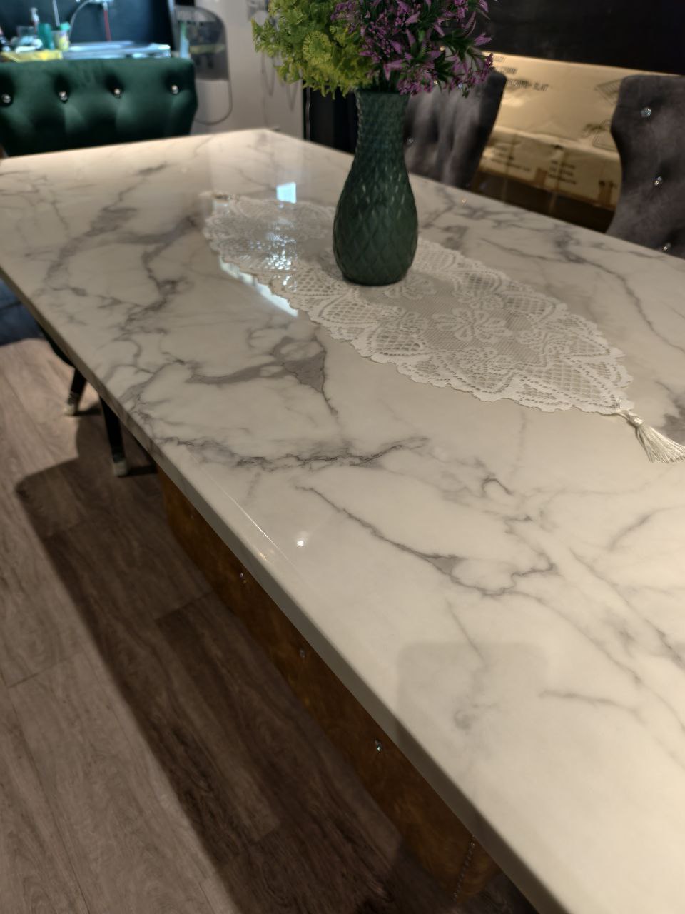 Marble dining table with black tapered legs in showroom