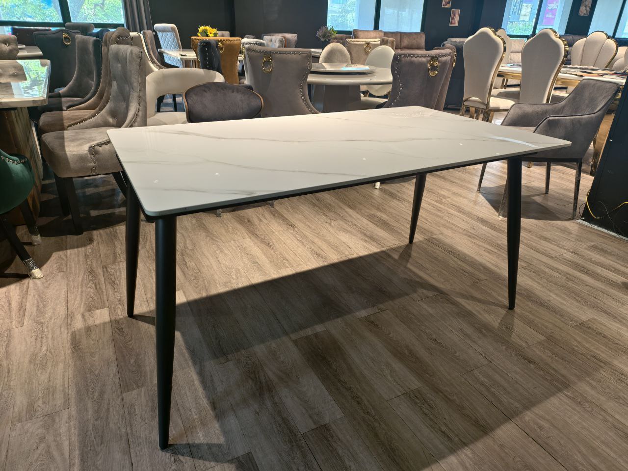 Rectangular marble-look dining table in showroom
