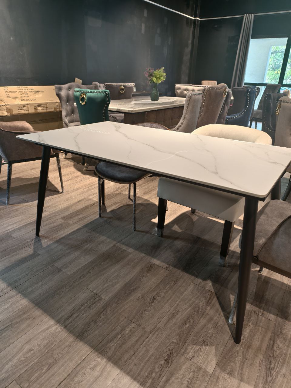 Rectangular marble-look dining table front view with black tapered legs