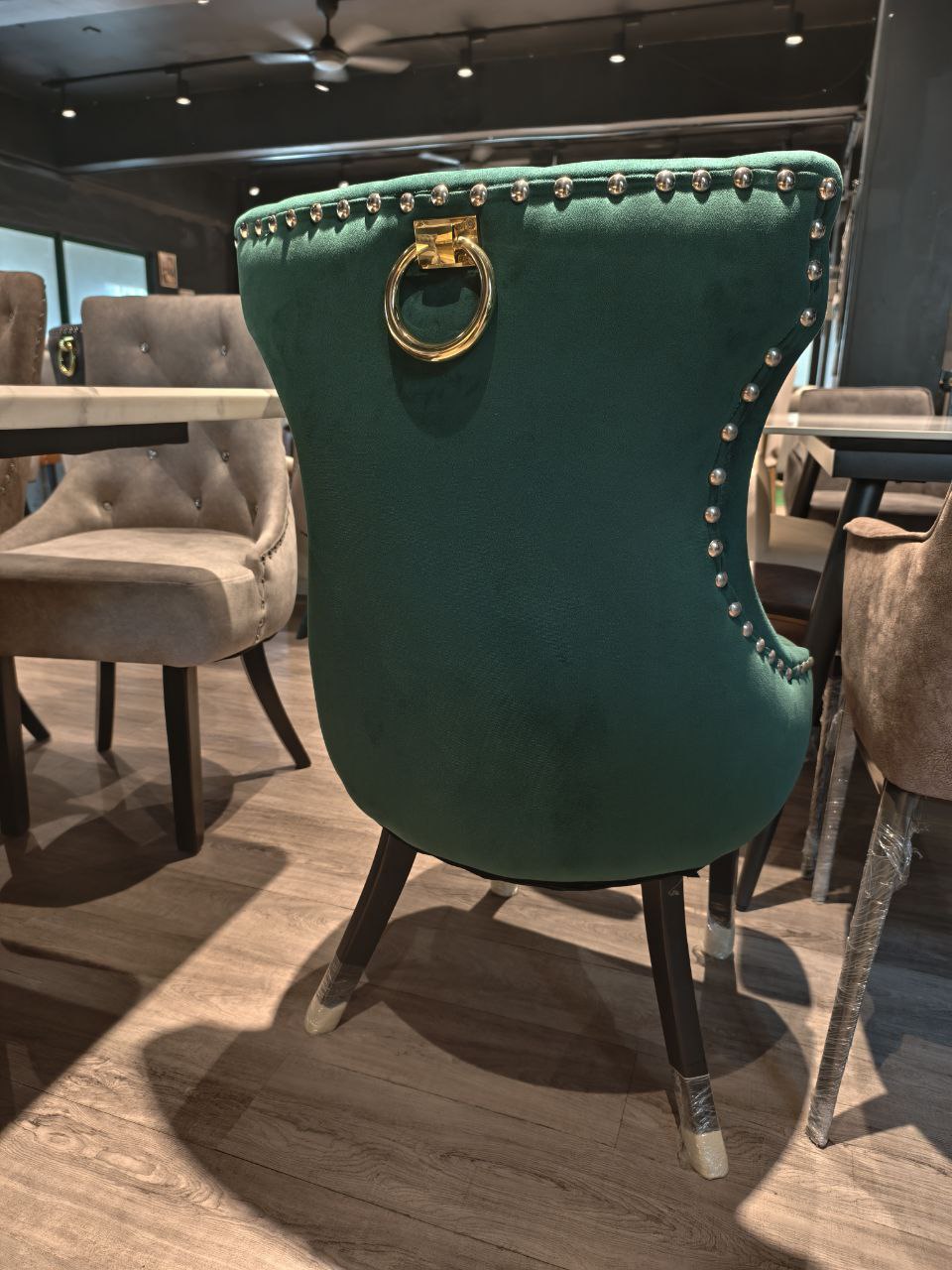 Green velvet Butterfly dining chair back view with gold ring handle