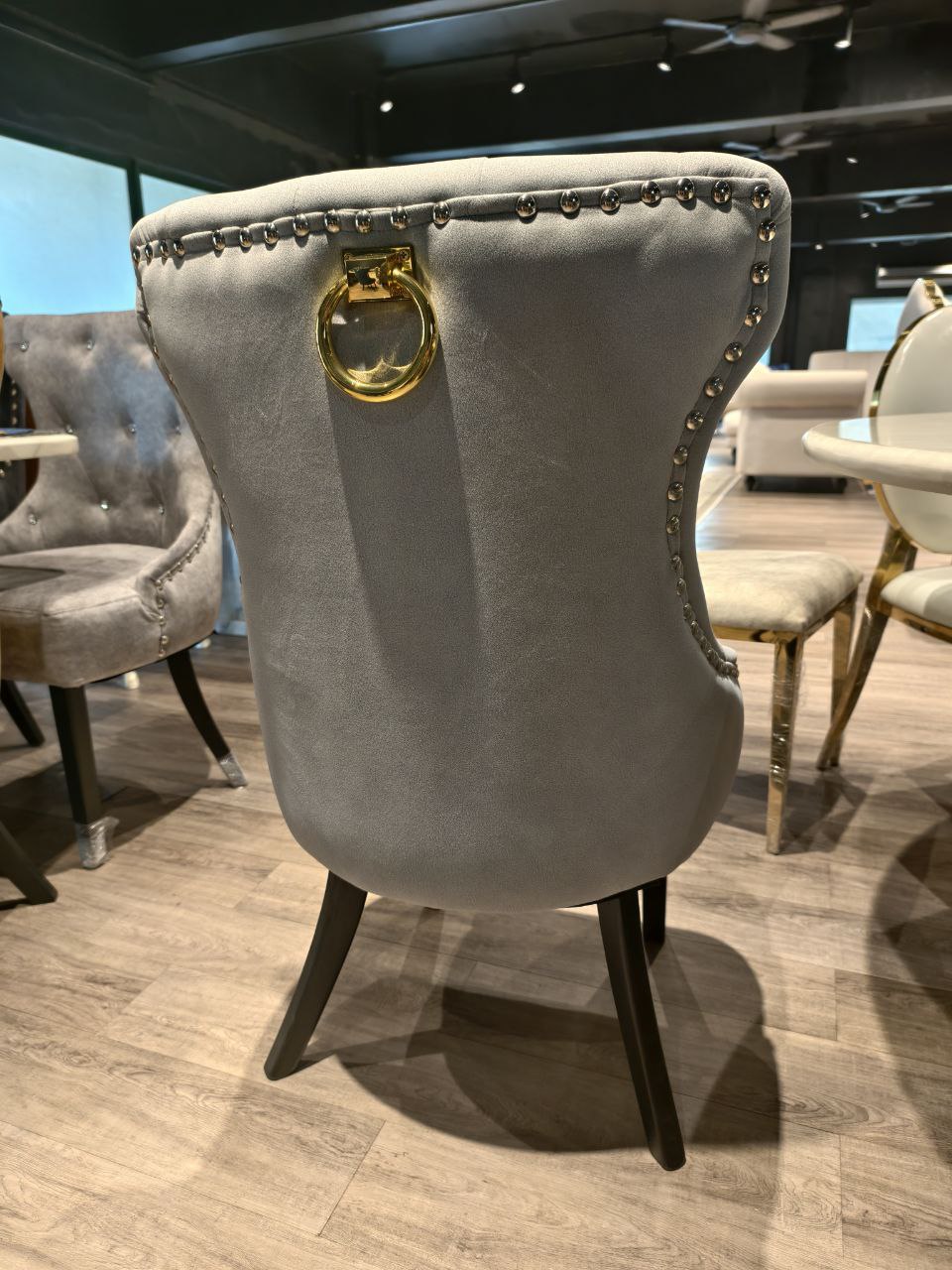 Grey Butterfly dining chair back view with gold ring handle and nailhead trim